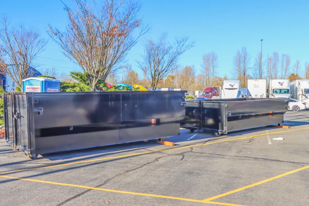 Professional dumpster rental service with roll-off container on residential driveway in Klamath Falls